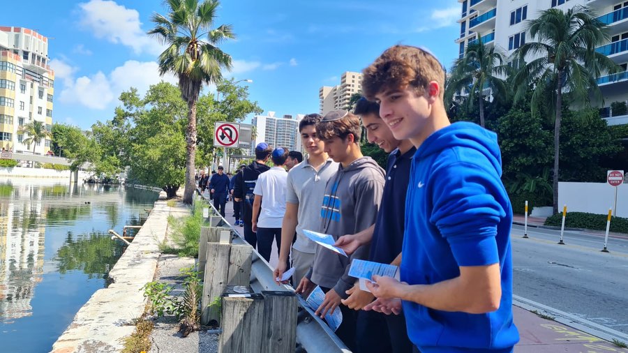 Jewish students outdoors, smiling and engaging in conversation.