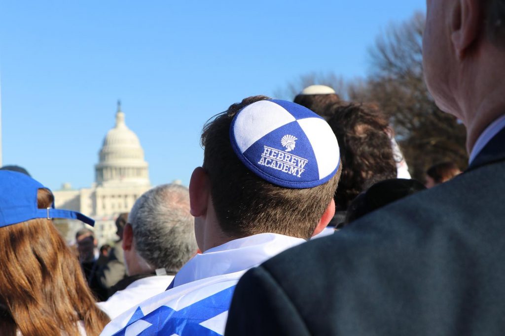 Close-up of a man wearing a Hebrew Academy kippah.