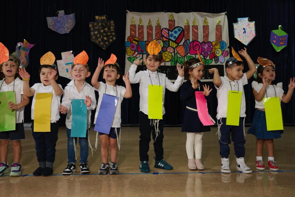 Happy children singing photo during a school performance.