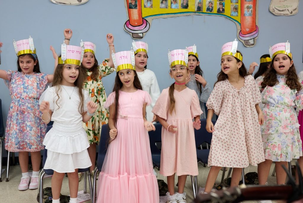 Group of young children singing happily.