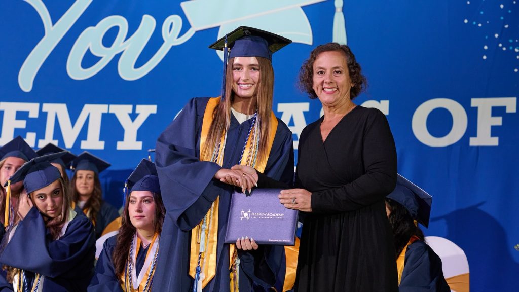 Graduate girl accepting her diploma during the ceremony.